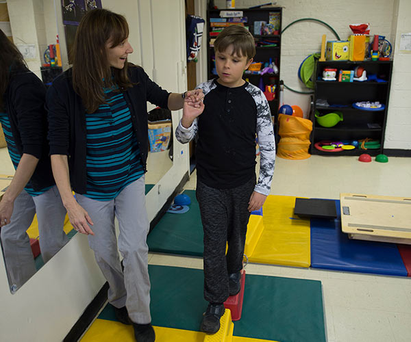 Gersh Academy Physical Therapist Walking a Student