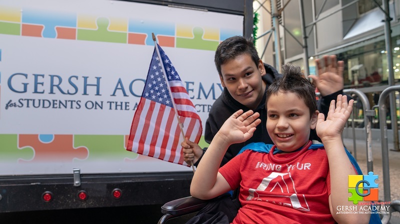 Gersh Academy Students Smiling and Waving on the Columbus Day parade Float