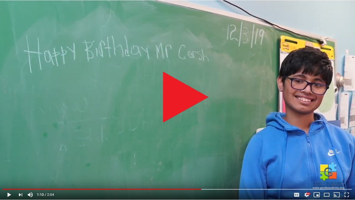 Student Stands in Front of Chalkboard at Gersh Academy