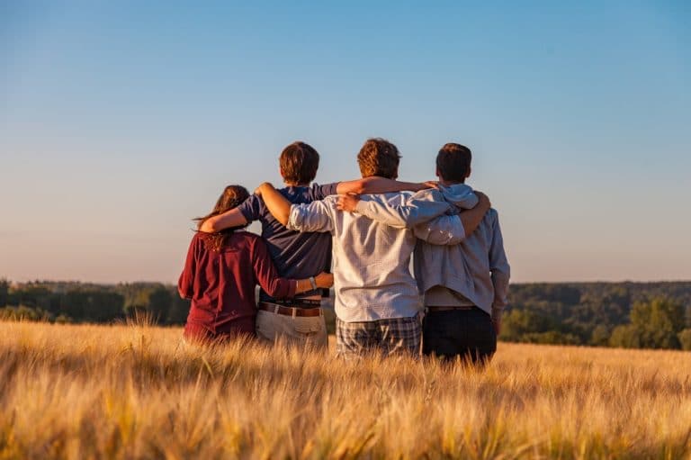 A family hugging in a field