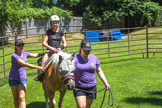 Student Riding a Horse and Engaging in Equine Therapy on the West Hills Campus